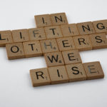 In Lifting Others, We Rise